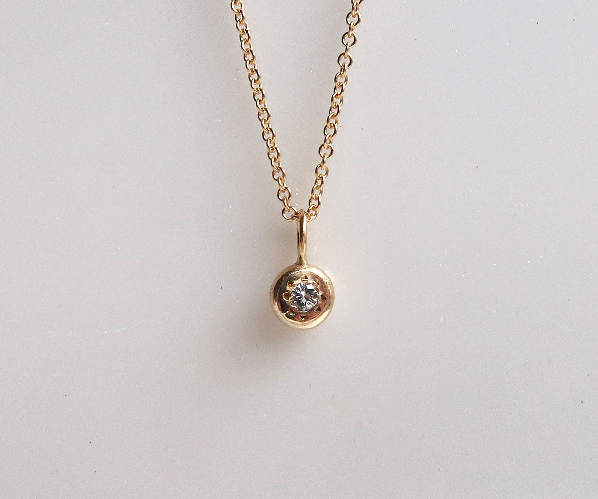Diamond yellow gold disc pendant