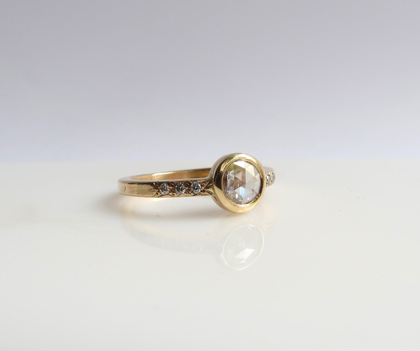 Bezel set rose cut diamond ring in yellow gold