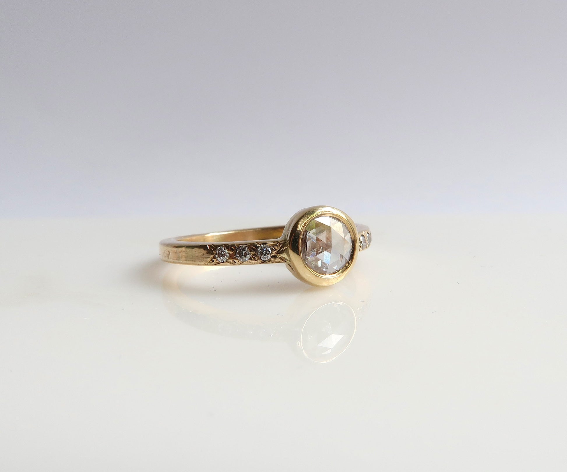 Bezel set rose cut diamond ring in yellow gold