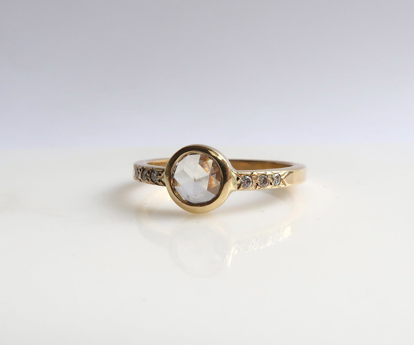 Bezel set rose cut diamond ring in yellow gold