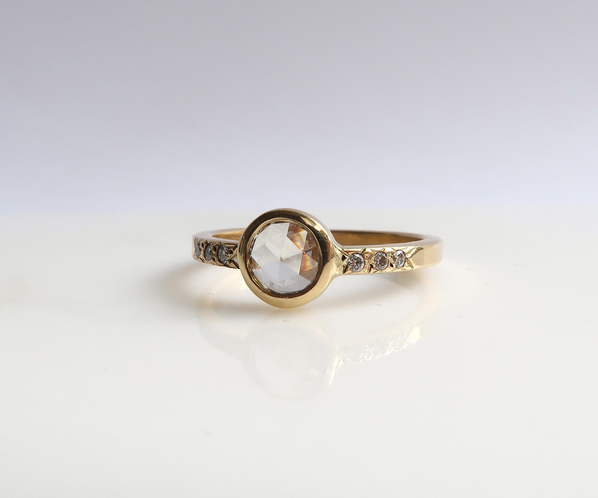 Bezel set rose cut diamond ring in yellow gold