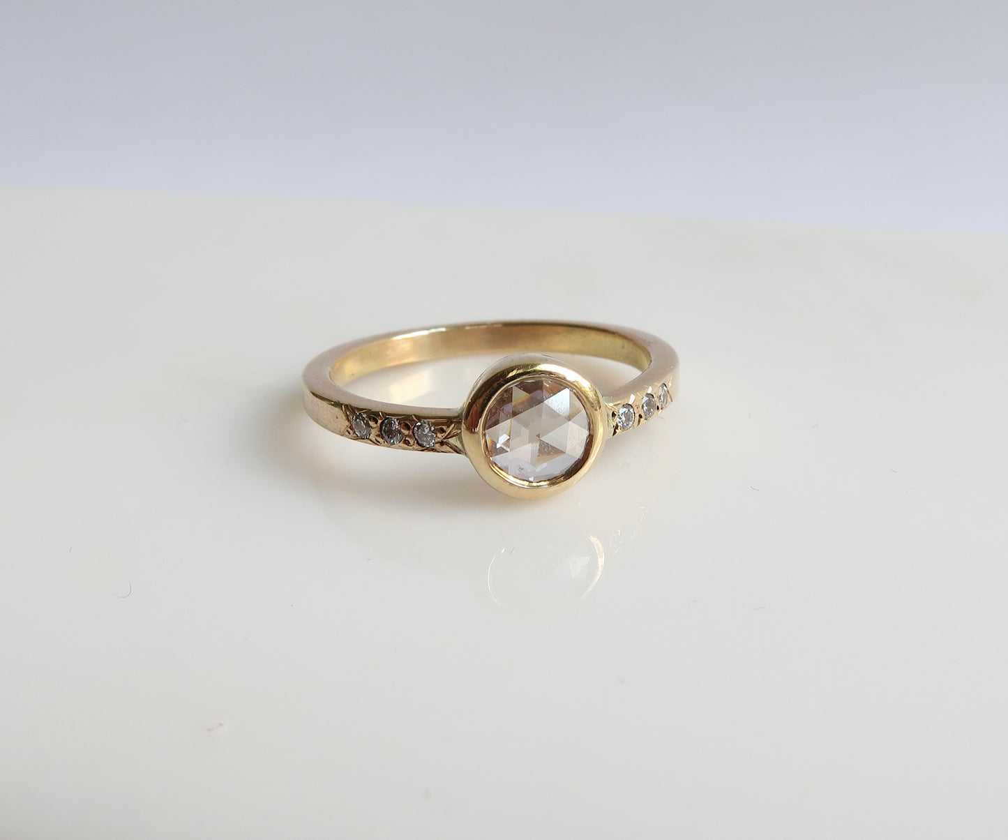 Bezel set rose cut diamond ring in yellow gold