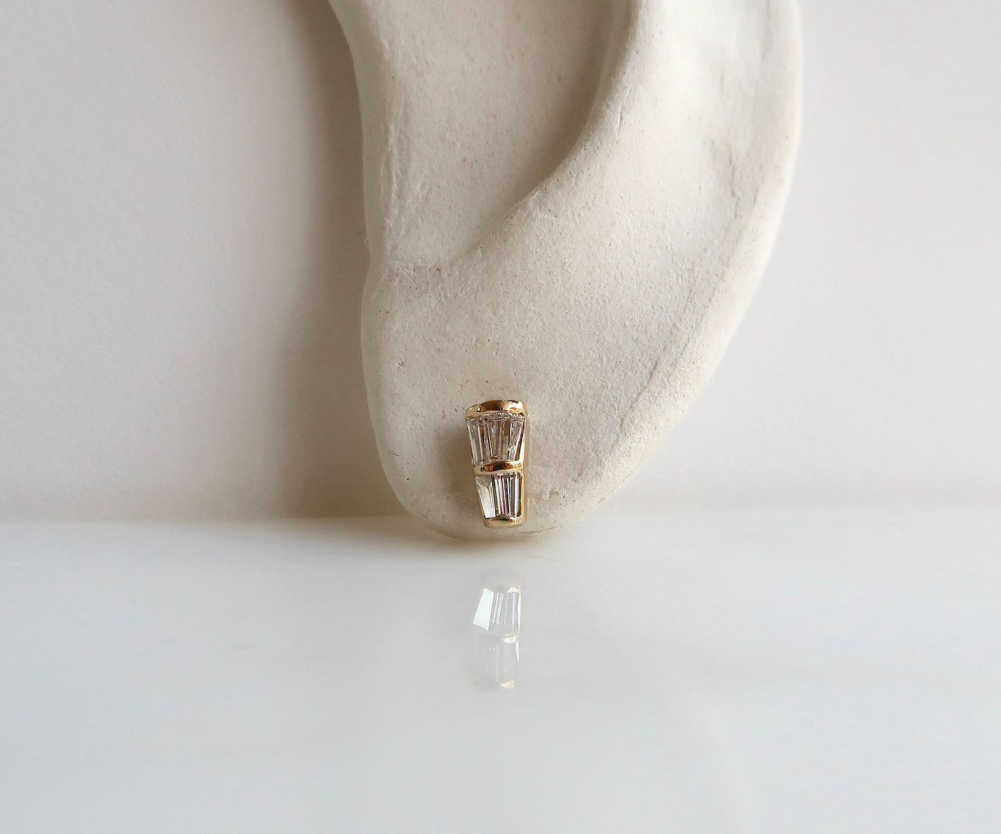 Baguette Diamond and Gold studs on ear 